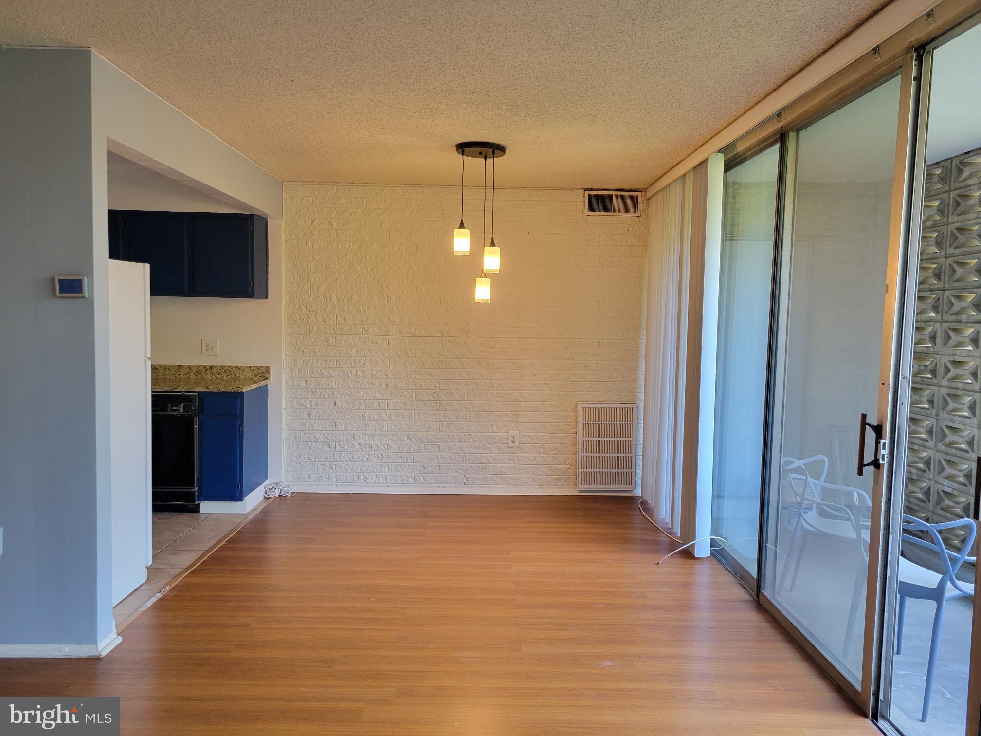 1830 Metzerott Road, Unit 103 Hyattsville, MD 20783 - Photo 10 of 41 a view of an empty room with wooden floor and a bathroom