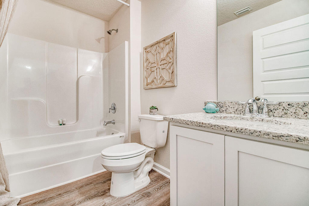 924 Sandbar Loop Crestview, FL 32539 - Photo 25 of 34 a bathroom with a granite countertop sink toilet and shower