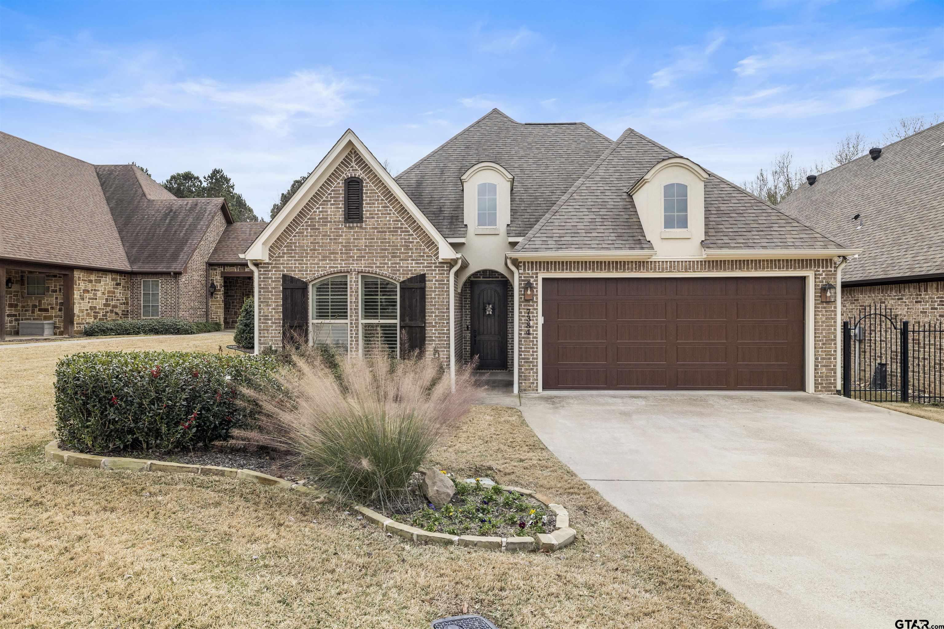 7384 Lake Pointe Cove Tyler, TX 75703 - Photo 1 of 18 a front view of a house with a yard