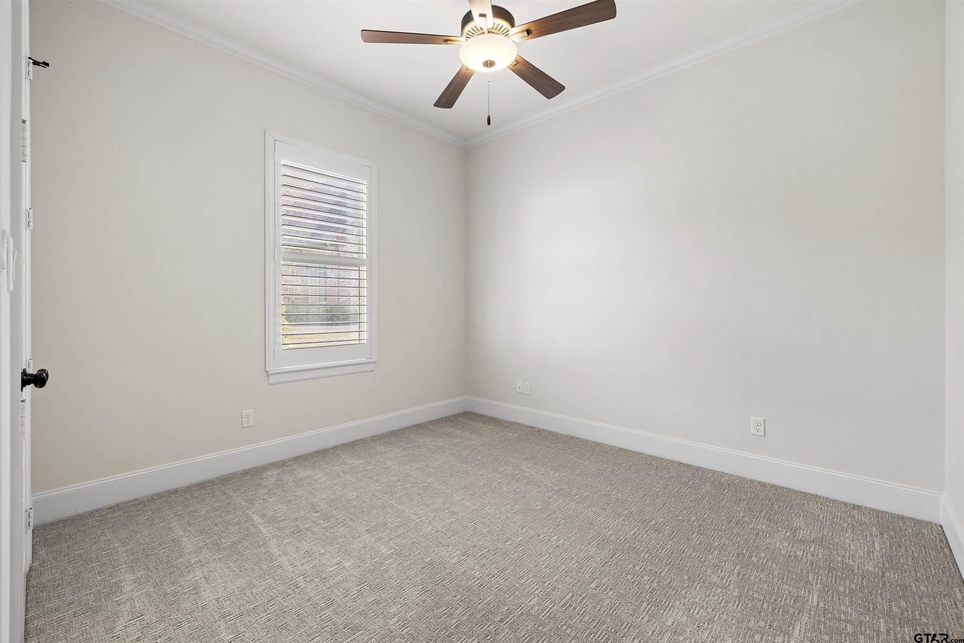 7384 Lake Pointe Cove Tyler, TX 75703 - Photo 13 of 18 an empty room with a window and a fan