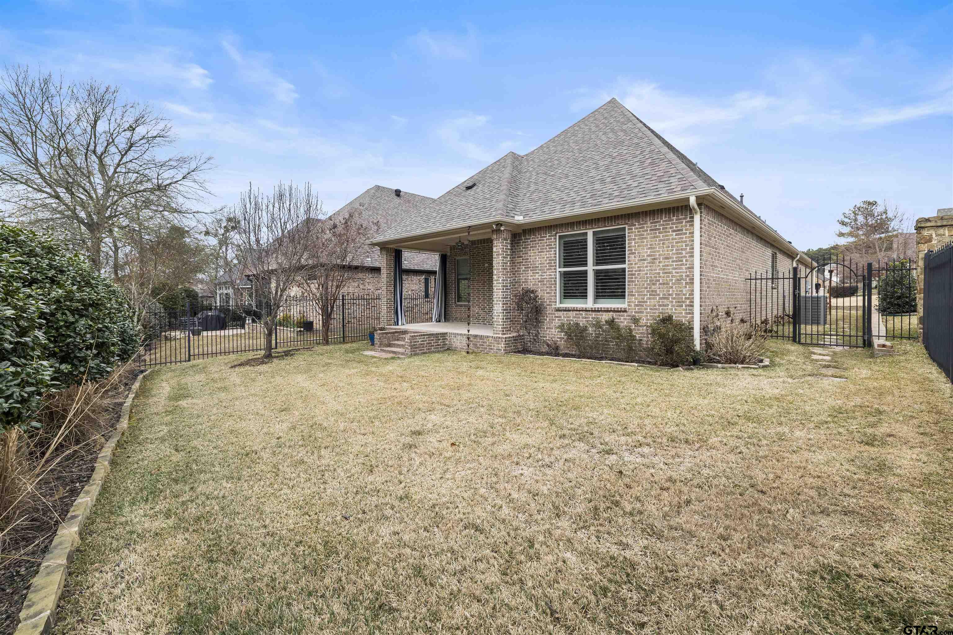 7384 Lake Pointe Cove Tyler, TX 75703 - Photo 17 of 18 a view of a house with a yard