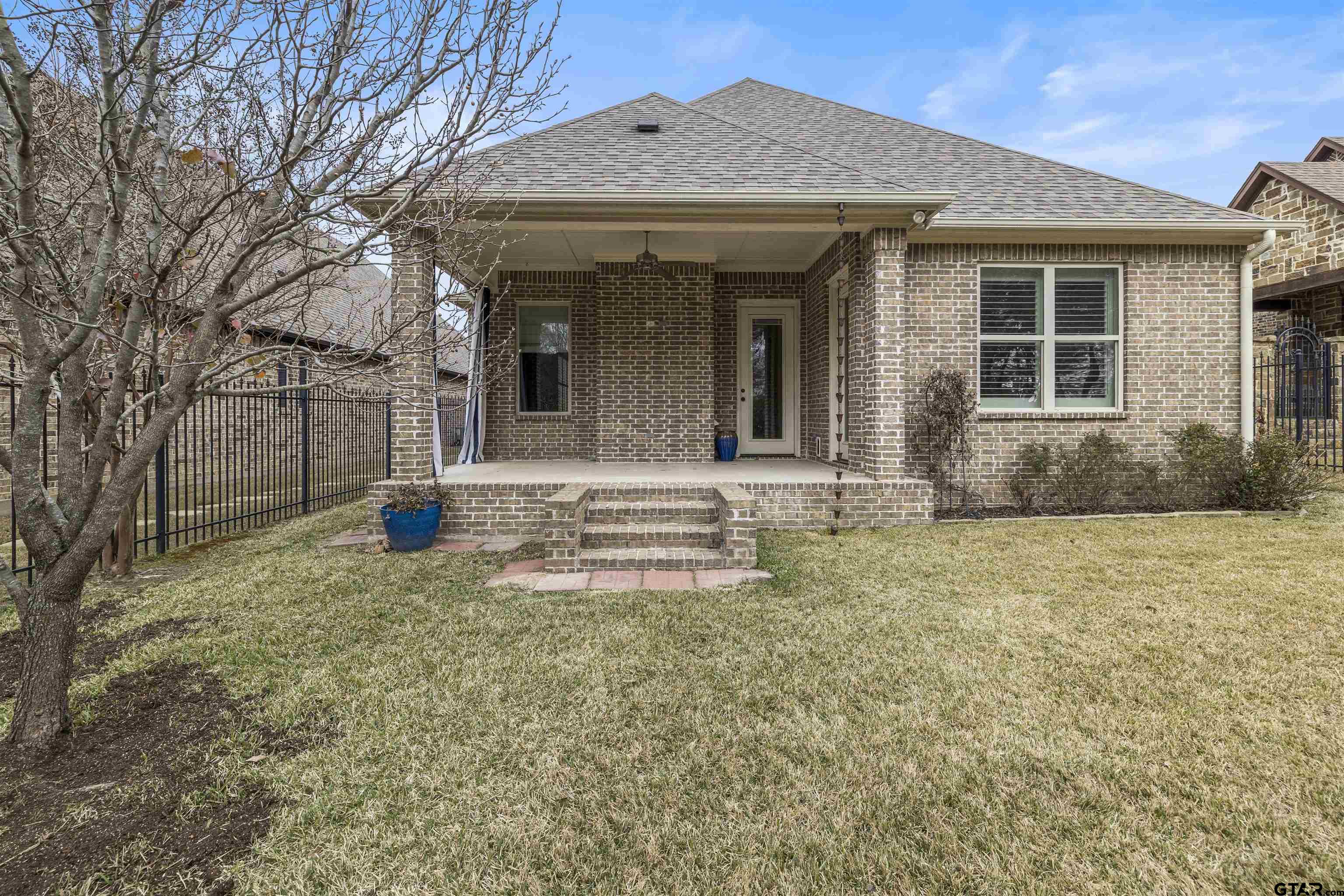 7384 Lake Pointe Cove Tyler, TX 75703 - Photo 18 of 18 a front view of a house with a yard
