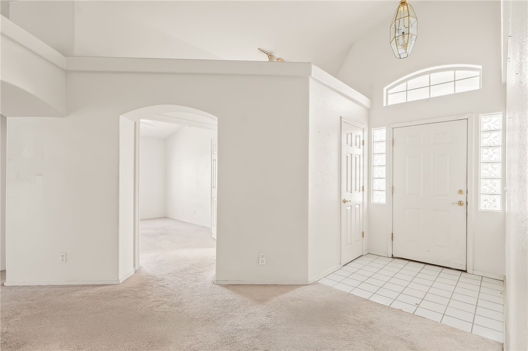 2853 Winchester Road Bullhead City, AZ 86442 - Photo 5 of 40 Welcoming entry area featuring a white front door with sidelight windows, a transom window, and a decorative light fixture