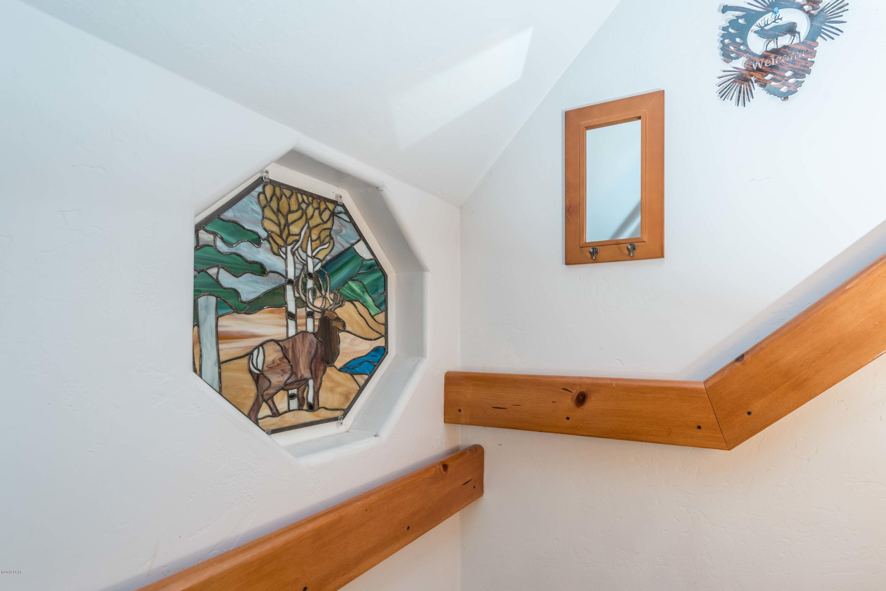 4690 South Hansen Road Kingman, AZ 86401 - Photo 23 of 94 Beautiful stained glass window at stairway landing.