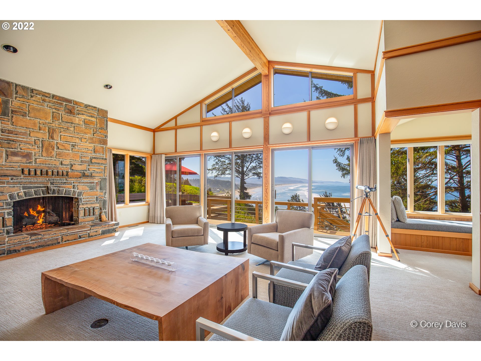 38500 Beulah Reed Road Nehalem, OR 97131 - Photo 11 of 30 a living room with furniture a fireplace and a floor to ceiling window