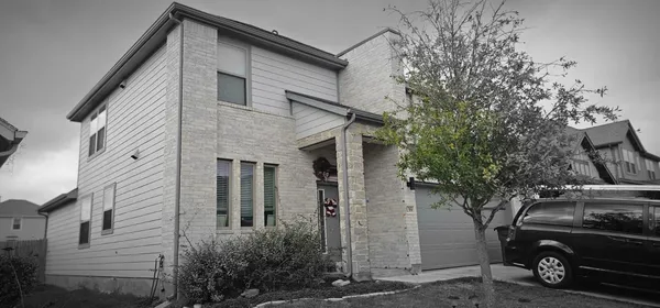 a view of a car parked front of a house