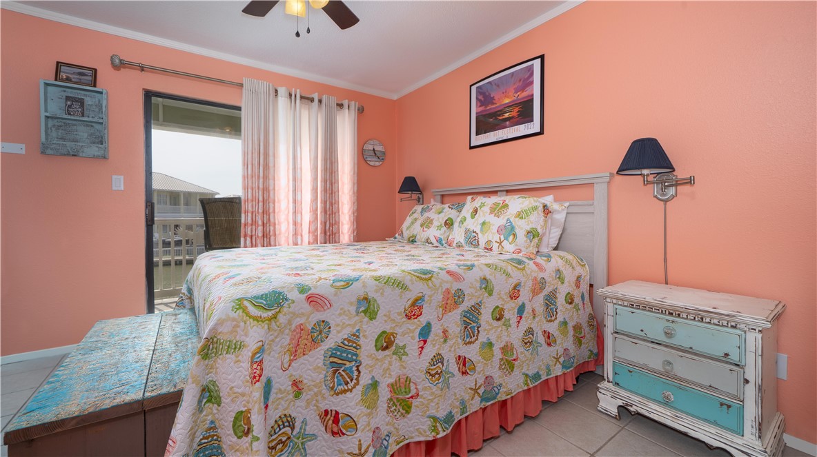 2290 North Fulton Beach Road Rockport, TX 78382 - Photo 18 of 26 a bedroom with a bed and a painting on the wall