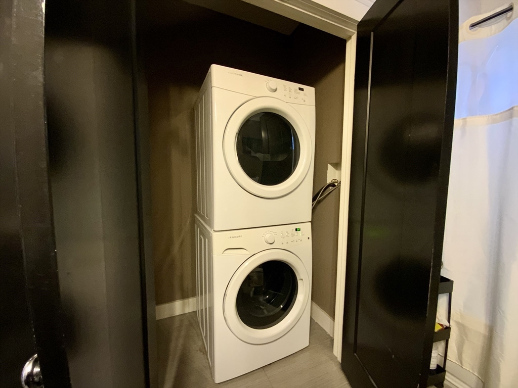 65 Broadway, Unit 1 Arlington, MA 02474 - Photo 12 of 15 a utility room with dryer and washer