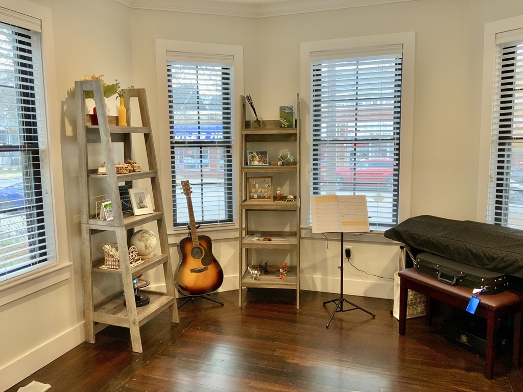 65 Broadway, Unit 1 Arlington, MA 02474 - Photo 3 of 15 a living room with furniture and wooden floor