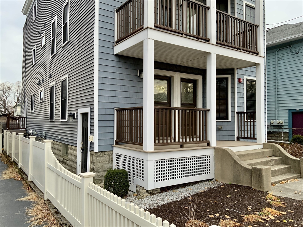 65 Broadway, Unit 1 Arlington, MA 02474 - Photo 5 of 15 a view of a house with stairs and wooden floor