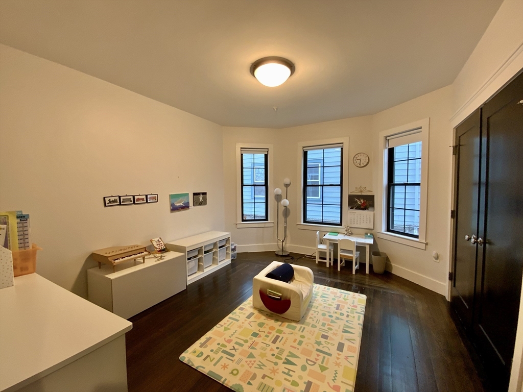 65 Broadway, Unit 1 Arlington, MA 02474 - Photo 10 of 15 a living room with furniture and a couch