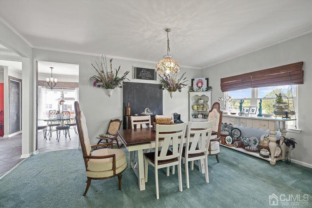 22 Mapleton Road Old Bridge, NJ 08857 - Photo 16 of 40 a view of a dining room and livingroom with furniture large windows a chandelier and wooden floor