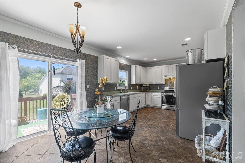 22 Mapleton Road Old Bridge, NJ 08857 - Photo 20 of 40 a dining room with furniture a chandelier and wooden floor