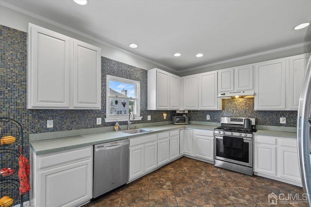 22 Mapleton Road Old Bridge, NJ 08857 - Photo 22 of 40 a kitchen with stainless steel appliances granite countertop a stove sink and cabinets