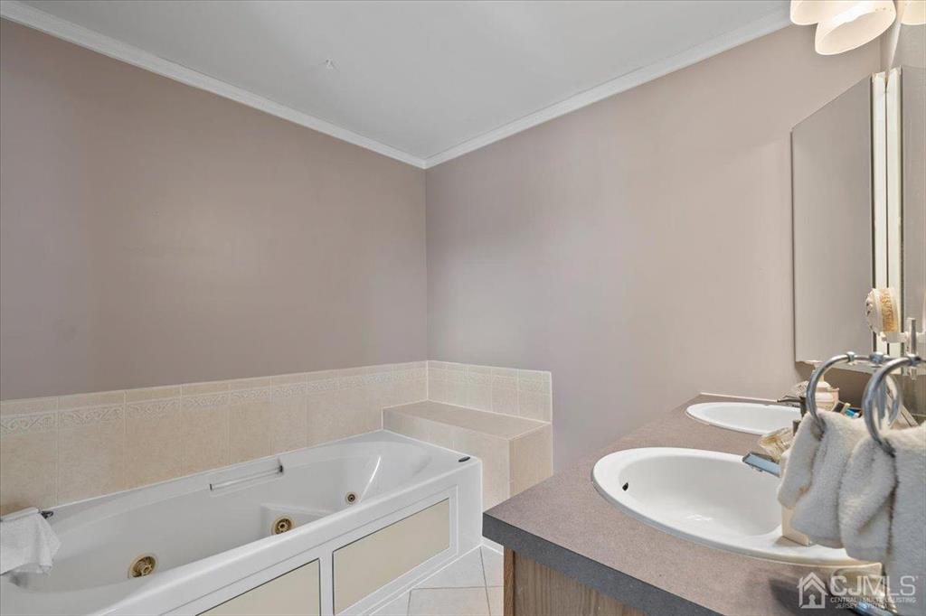 22 Mapleton Road Old Bridge, NJ 08857 - Photo 26 of 40 a bathroom with a tub sink and mirror