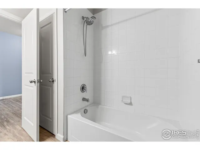 a bathroom with a bathtub a toilet and a shower