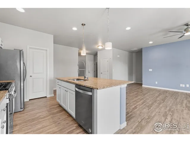 a kitchen with granite countertop a stove and a sink