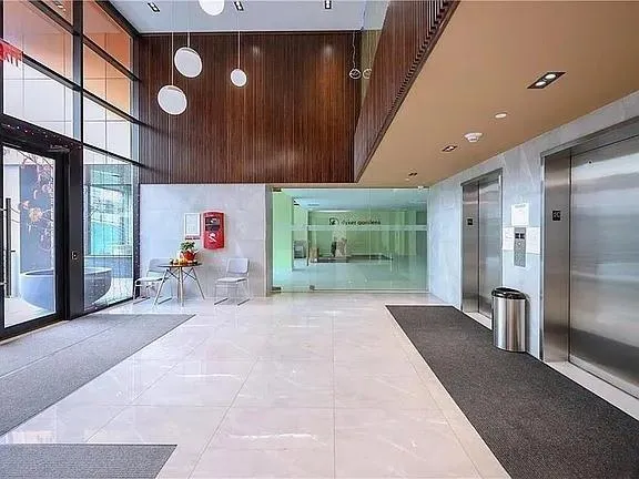 a view of a hallway with seating area