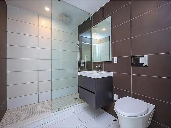 a bathroom with a toilet a sink and mirror