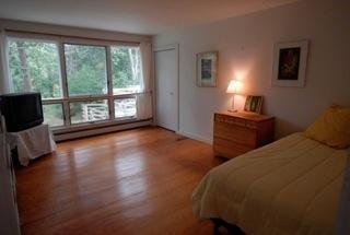365 Chequessett Neck Road Wellfleet, MA 02667 - Photo 10 of 19 a bedroom with two beds and a large window