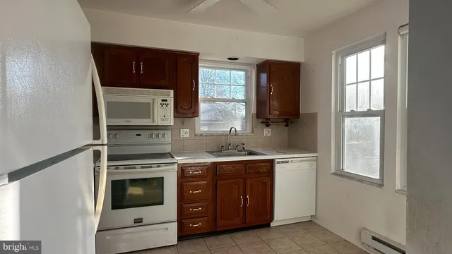 a kitchen with a stove microwave and sink