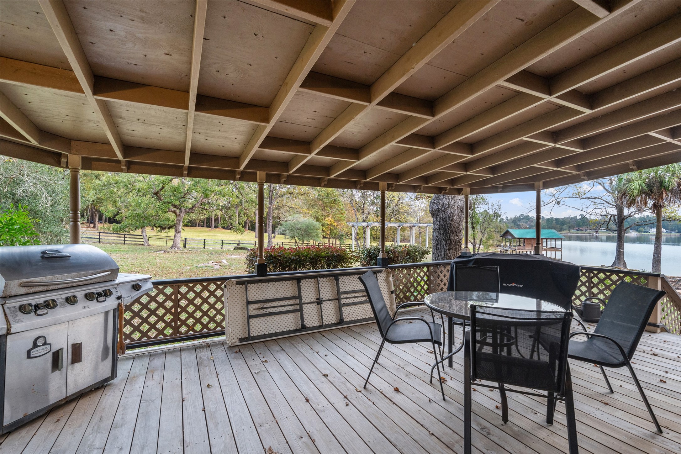 186 Lake Road Huntsville, TX 77320 - Photo 24 of 48 a view of a chairs and table on the deck