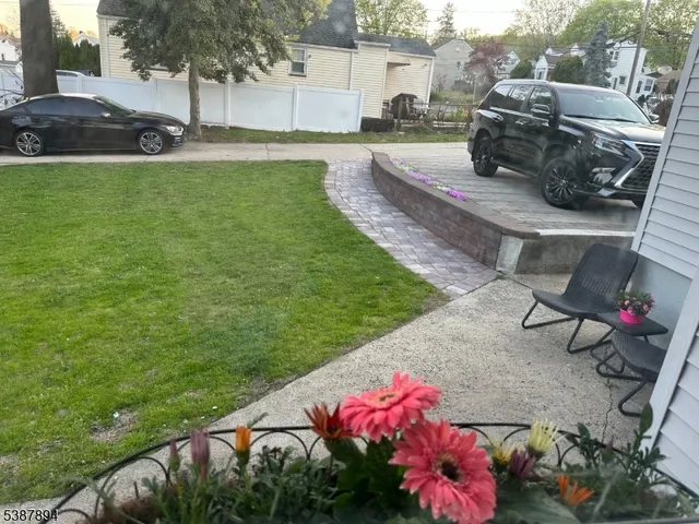 a view of a backyard with table and chairs potted plants