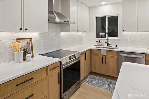 a kitchen with a sink stove and cabinets