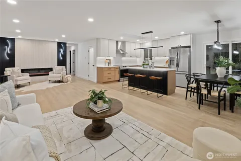 a living room with furniture a refrigerator and kitchen view