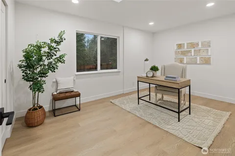 a living room with furniture potted plant and a window