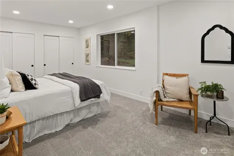 a bedroom with a bed and chair