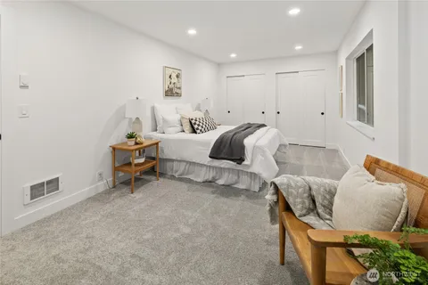 a bedroom with furniture and a wooden floor