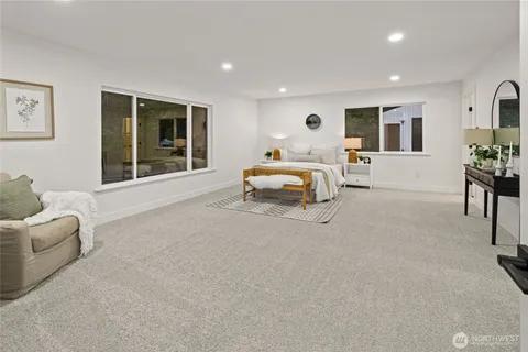 a bedroom with furniture and a large window