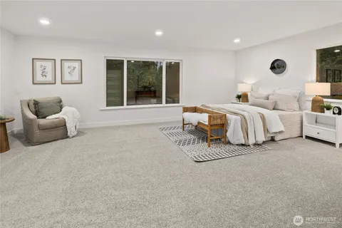 a spacious bedroom with a bed and glass window