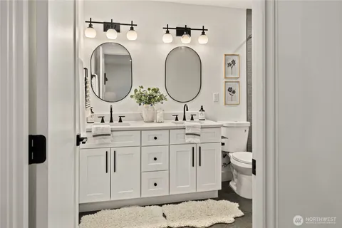 a bathroom with a sink a toilet and a mirror