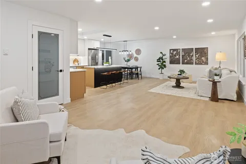 a living room with furniture and kitchen view