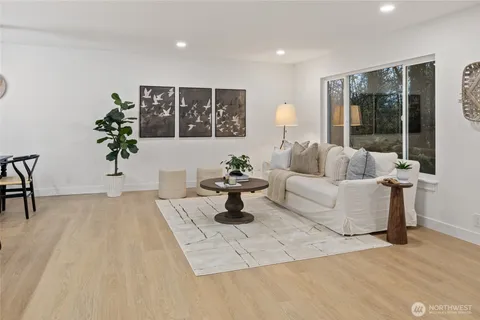 a living room with furniture and a potted plant