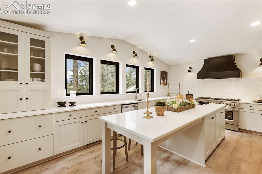 1320 Spring Valley Drive Colorado Springs, CO 80921 - Photo 13 of 46 a kitchen with a sink stove and cabinets