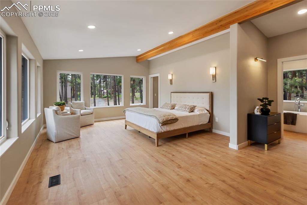 1320 Spring Valley Drive Colorado Springs, CO 80921 - Photo 19 of 46 a spacious bedroom with a bed and glass door