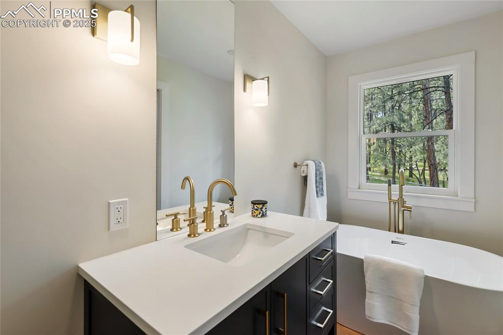 1320 Spring Valley Drive Colorado Springs, CO 80921 - Photo 31 of 46 a bathroom with a sink and a vanity