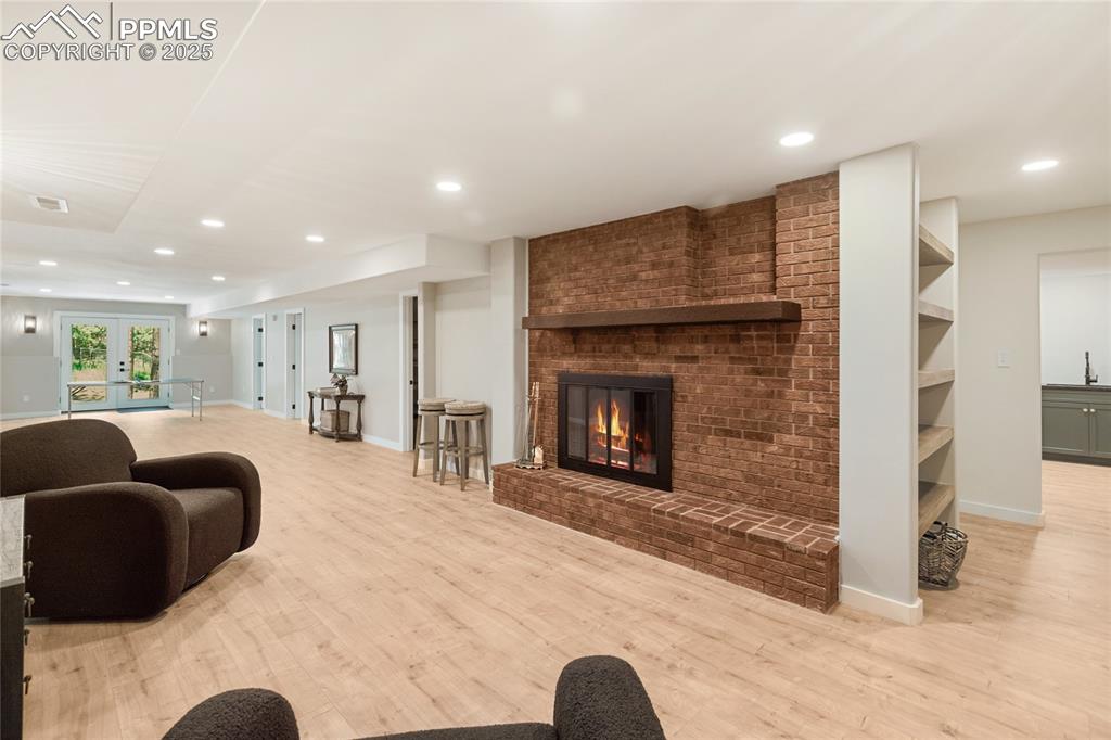 1320 Spring Valley Drive Colorado Springs, CO 80921 - Photo 32 of 46 a living room with furniture and a fireplace