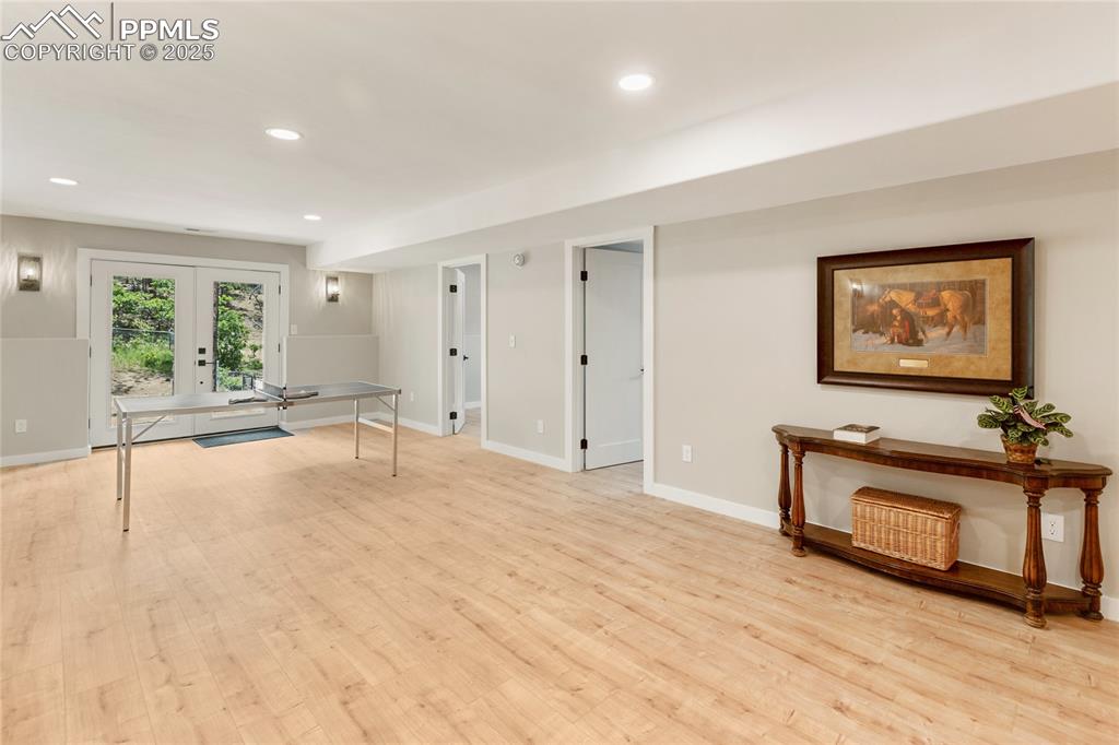 1320 Spring Valley Drive Colorado Springs, CO 80921 - Photo 33 of 46 a view of an empty room with a window and wooden floor