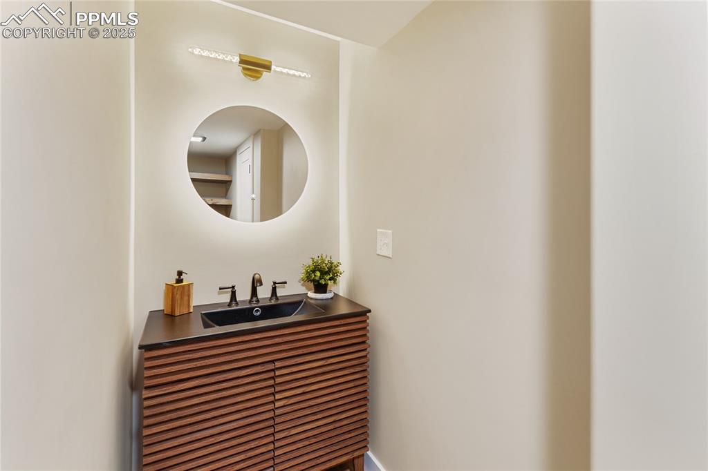 1320 Spring Valley Drive Colorado Springs, CO 80921 - Photo 37 of 46 a bathroom with a sink and a mirror