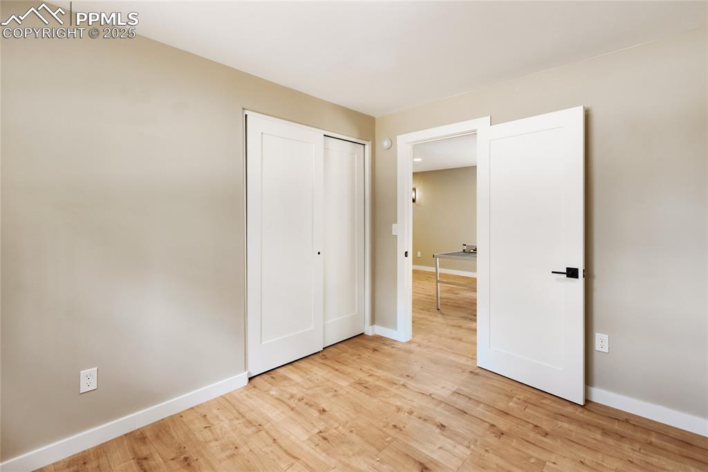 1320 Spring Valley Drive Colorado Springs, CO 80921 - Photo 39 of 46 a view of an empty room with wooden floor
