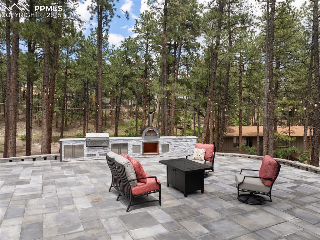 1320 Spring Valley Drive Colorado Springs, CO 80921 - Photo 42 of 46 an outdoor sitting area with couch and a fire pit