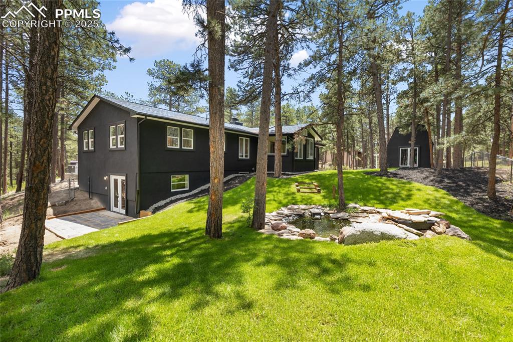 1320 Spring Valley Drive Colorado Springs, CO 80921 - Photo 9 of 46 a view of a backyard with a tree