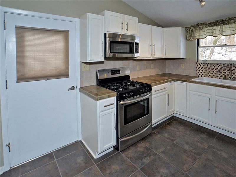 109 Leslie Road Monroeville, PA 15146 - Photo 8 of 24 All appliances included in this updated Kitchen. Door is to go outside to the side deck.