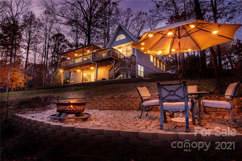 254 Beaten Path Road Mooresville, NC 28117 - Photo 2 of 35 a backyard of a house with table and chairs under an umbrella