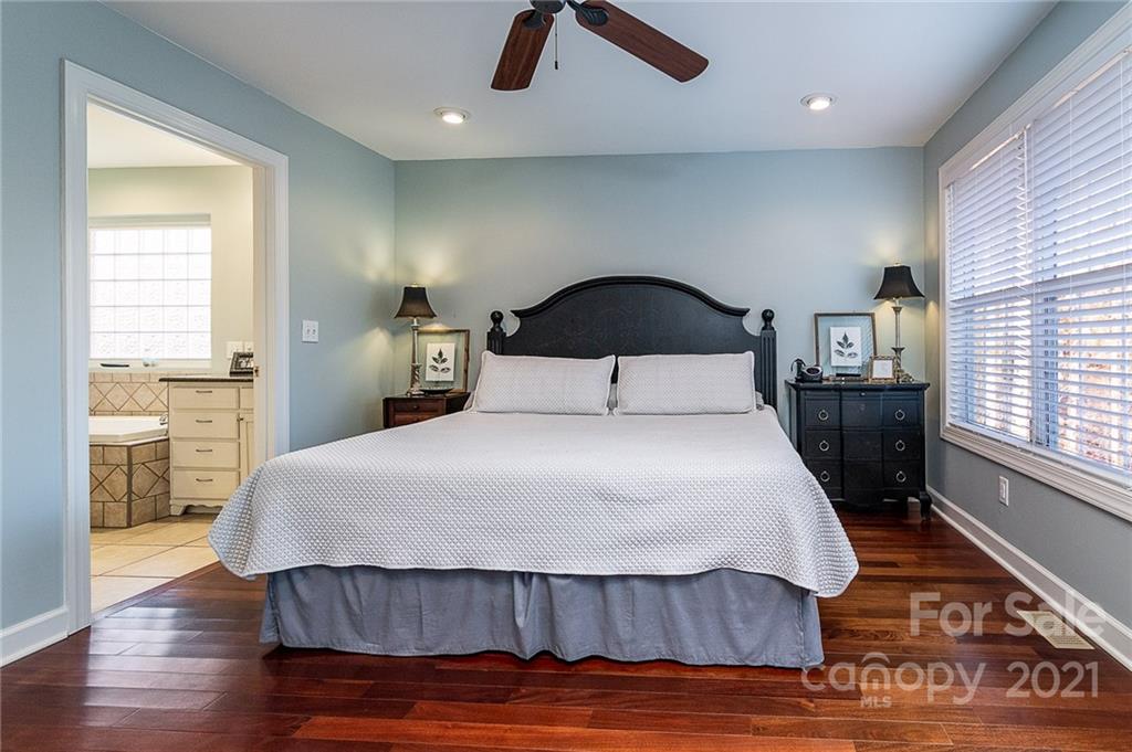 254 Beaten Path Road Mooresville, NC 28117 - Photo 11 of 35 a bedroom with a bed and wooden floor