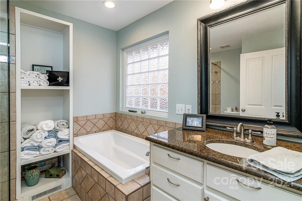 254 Beaten Path Road Mooresville, NC 28117 - Photo 13 of 35 a bathroom with a granite countertop sink and a mirror